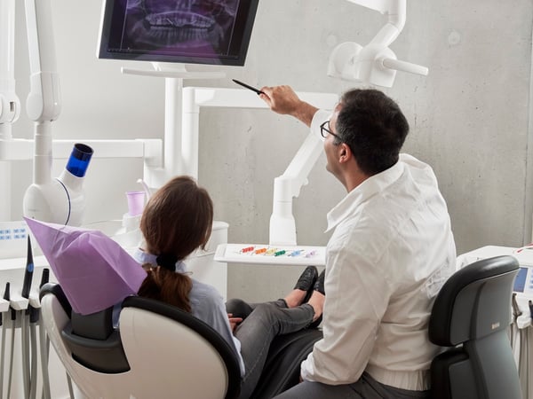 Dentist consulting with a patient at Reliance Hospital