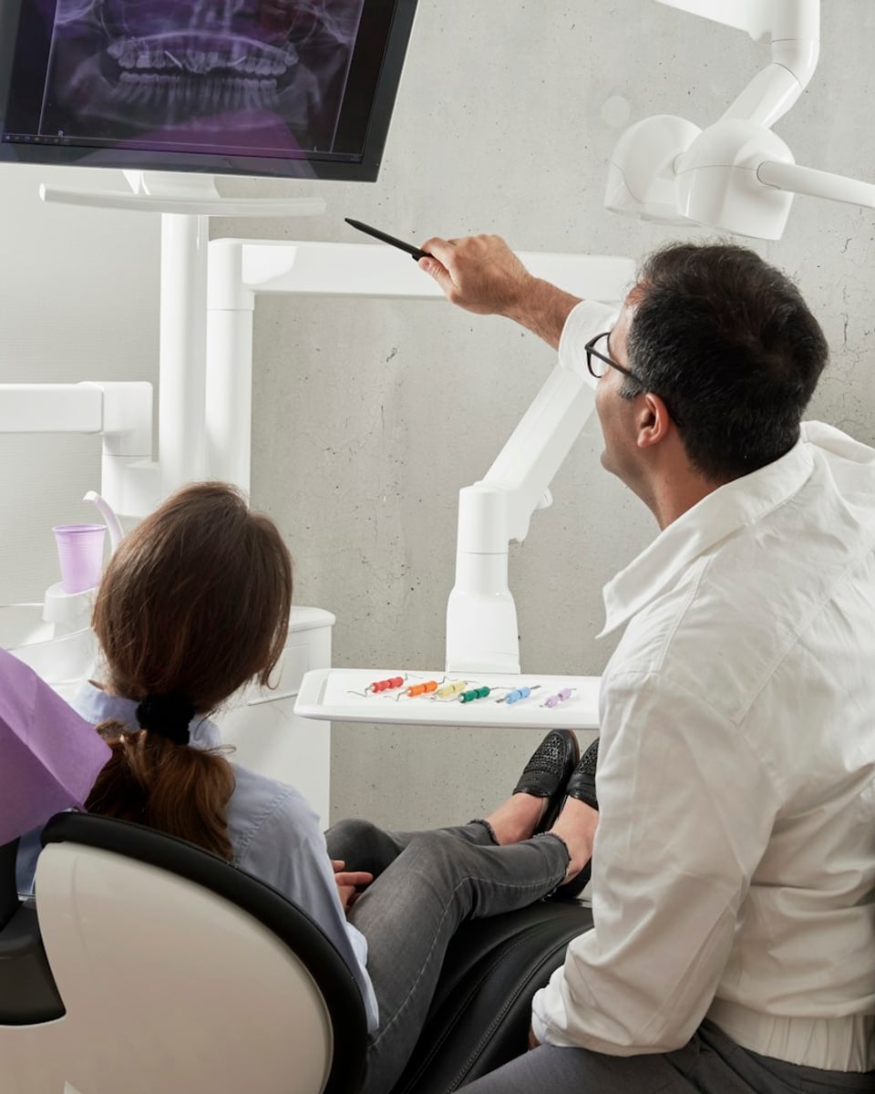 Dentist consulting with a patient at Reliance Hospital