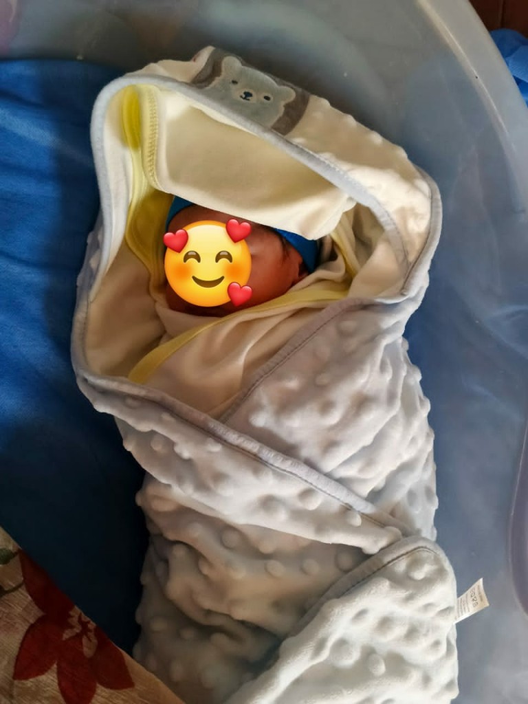 Newborn baby boy in hospital bassinet after delivery at Reliance Hospital under the Motherhood Premium Package